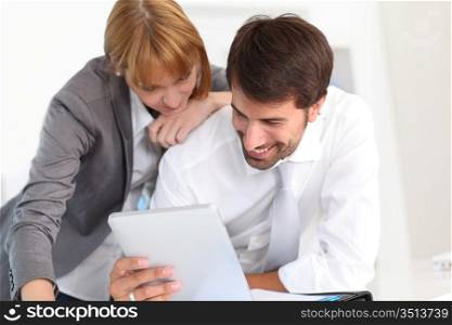 Business people in office using electronic tablet