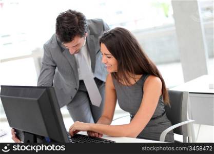 Business people in office working on desktop computer