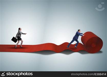 Business people in success concept with red carpet