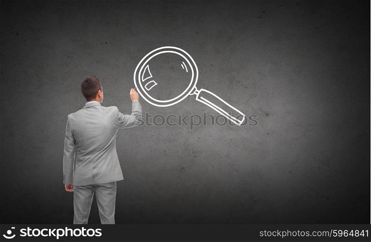 business, people, information, investigation and research concept - businessman drawing magnifier from back over dark gray concrete wall background