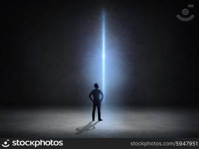 business, people, inspiration and inspiration concept - businessman looking at laser light ray over empty dark room background from back