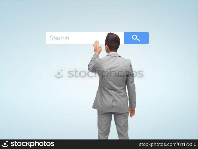 business, people, internet and technology concept - businessman touching virtual projection of browser search bar from back
