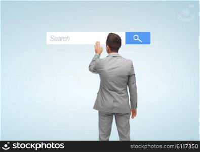 business, people, internet and technology concept - businessman touching virtual projection of browser search bar from back