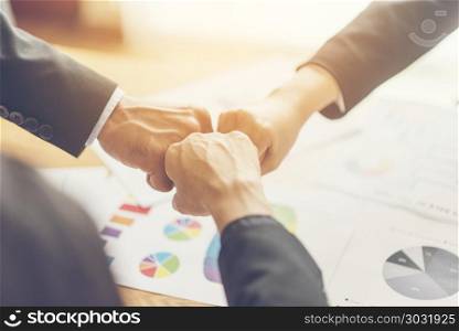 business people join hand while meeting in office