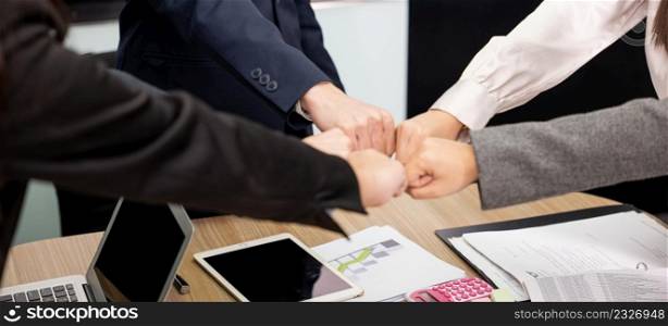 Business people join punching fists bump hands as team their meeting, Giving touch punch together of power teamwork, Business group winning successful company achieving goals with determined staff
