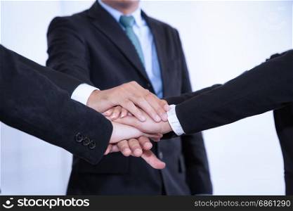business people join stack hand while meeting in office as team teamwork togetherness collaboration concept