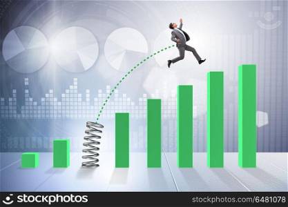 Business people jumping over bar charts