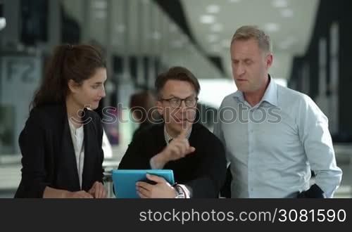 Business people looking at a digital tablet in cafe during a meeting