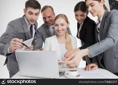 Business people looking at laptop screen working together, they rejoice. Business people looking at laptop screen