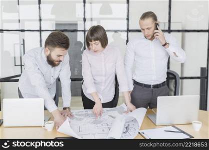business people looking plans office