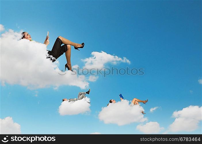 Business people lying on clouds