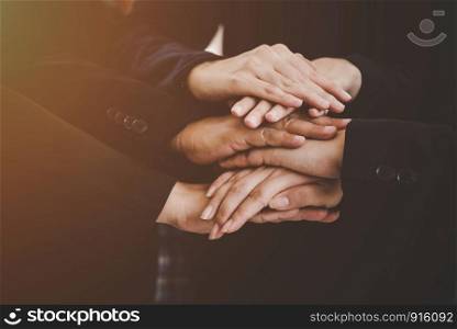Business people making pile of hands for startup new project. Business and togetherness concept. Cooperation and Successful concept. Close up view