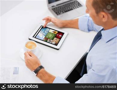 business, people, mass media and technology concept - businessman with tablet pc reading internet news and drinking coffee in office