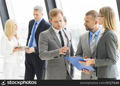 Business people meeting. Business people talking at meeting in office near window
