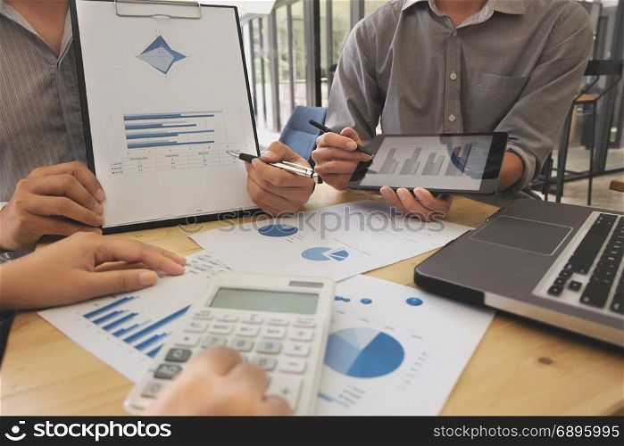 Business people meeting discussing on digital tablet with data graph