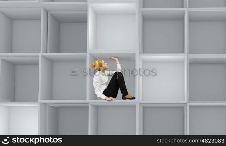 Business people. Miniature of young businesswoman sitting in cube