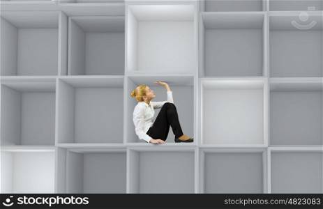 Business people. Miniature of young businesswoman sitting in cube
