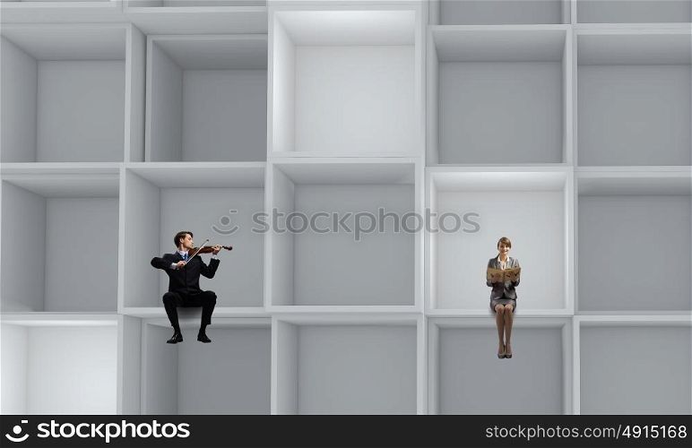 Business people. Miniatures of business people standing in cube
