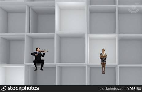 Business people. Miniatures of business people standing in cube