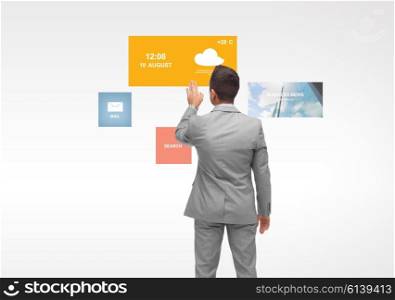 business, people, multimedia and technology concept - businessman touching virtual projection from back