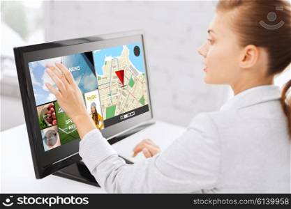 business, people, navigation and technology concept - woman with gps navigator map on computer touchscreen in office