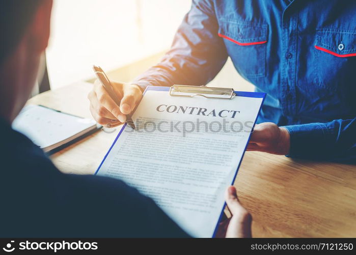 Business people negotiating a contract between two colleagues