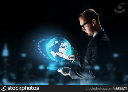 business, people, network, mass media and future technology concept - businessman with tablet pc computer and earth globe hologram over dark background