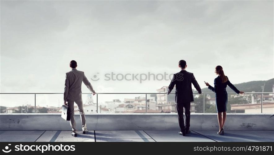 Business people on building top. Outdoor business meeting on roof of building