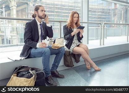 Business people on business trip using phone and digital tablet, New York, USA