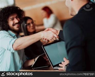 Business people or lawyers shaking hands finishing up meetings or negotiations in sunny offices. Business handshake and partnership. Business people or lawyers shaking hands finishing up meeting or negotiation in sunny office.