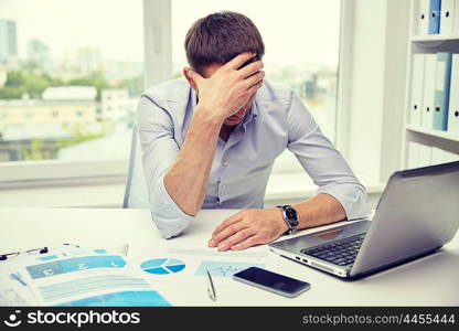 business, people, paperwork and deadline concept - stressed businessman with papers and charts sitting at table in office