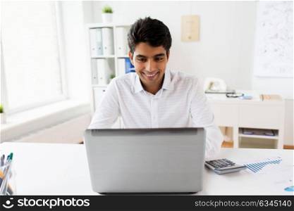 business, people, paperwork and technology concept - businessman with laptop computer and papers at office. businessman with laptop and papers at office