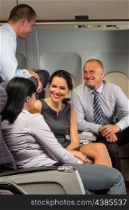 Business people passengers flying airplane talking travel flight cabin
