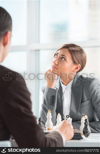 Business people playing chess at office. Business strategy concept
