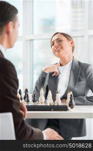 Business people playing chess at office. Business strategy concept