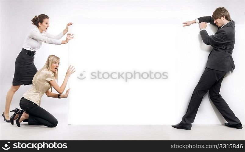 Business people pushing an empty white board