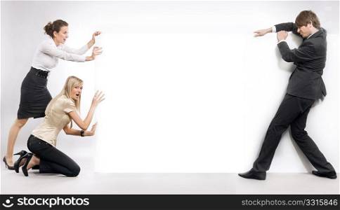 Business people pushing an empty white board