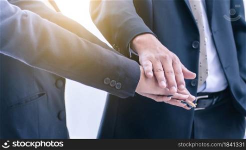 Business people putting their hands together for working collaboration. Selective focus on their hands.