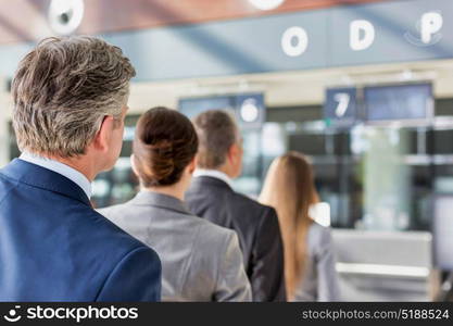 Business people queueing for check in at airport