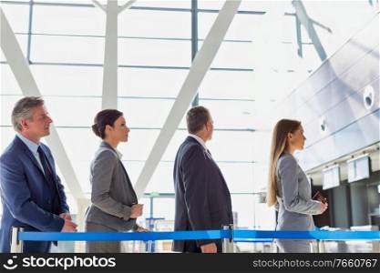 Business people queueing for check in at airport