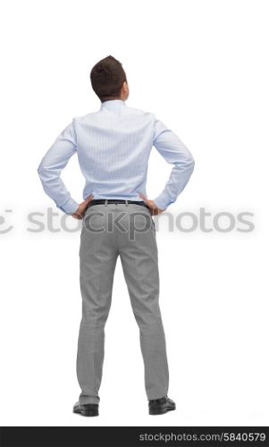 business, people, rear view and office concept - businessman looking up from back