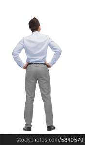 business, people, rear view and office concept - businessman looking up from back