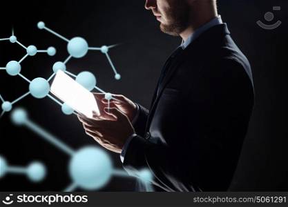 business, people, science, biology and future technology concept - close up of businessman with transparent tablet pc computer and virtual molecule over black background. close up of businessman with transparent tablet pc