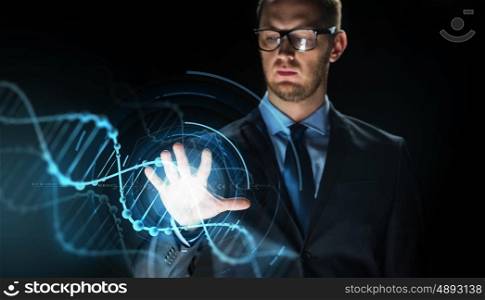 business, people, science, future technology and genetics concept - close up of businessman touching virtual dna molecule projection over dark background