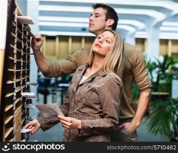 Business people searching for letters in shelves at office
