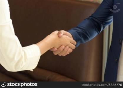 Business people shaking hands after closing deal in office, partnership merger and acquisition concept