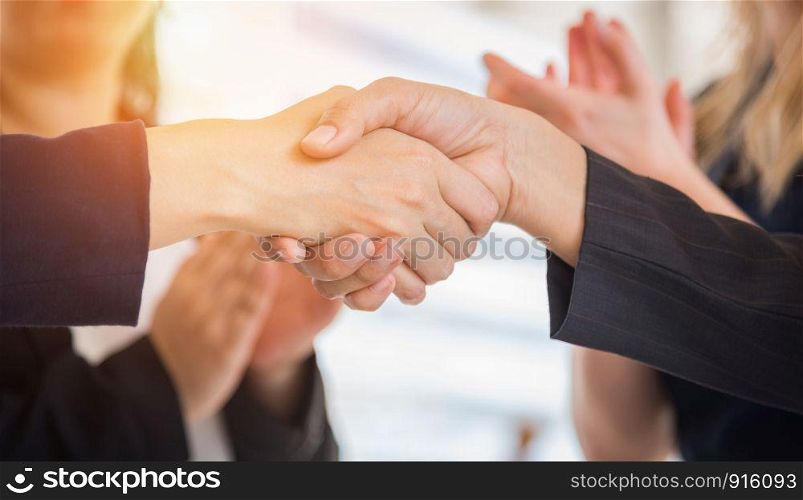 Business people shaking hands after finish reach agreement for startup new project. Negotiating and Happy working concept. Handshake gesturing connection deal concept. People and teamwork theme