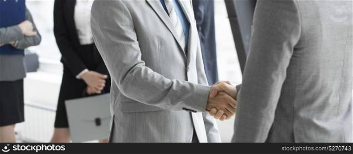 Business people shaking hands. Business people shaking hands, finishing up a meeting in office