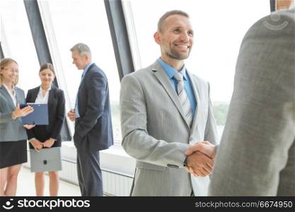 Business people shaking hands. Business people shaking hands, finishing up a meeting in office