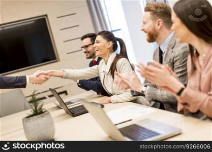 Business people shaking hands finishing up a meeting in modern office